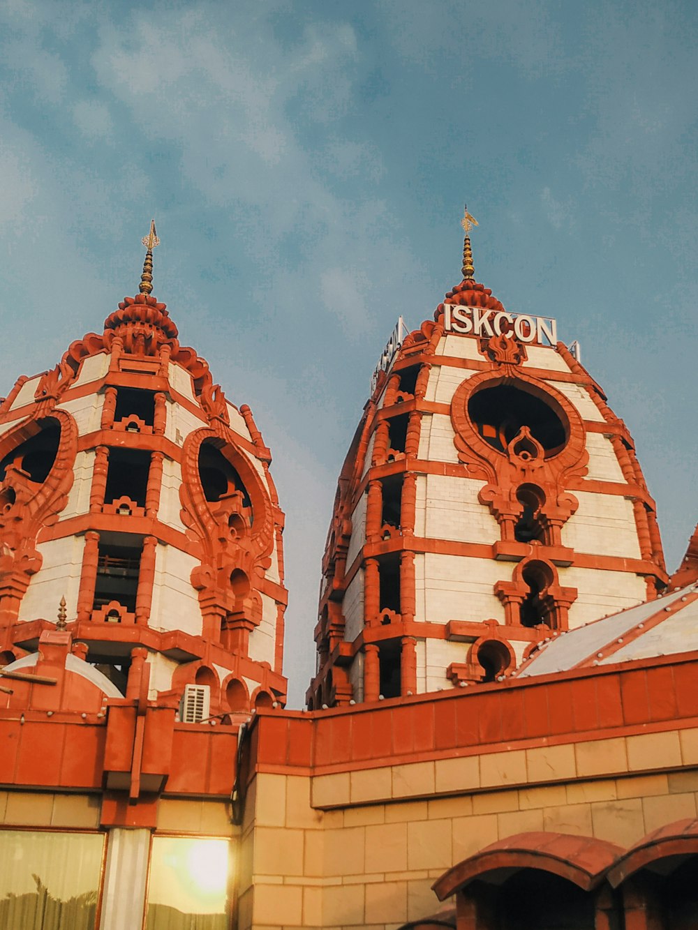 a building with two towers and a sky background