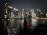Evening city skyline with a model in Lumina apparel looking out over the view