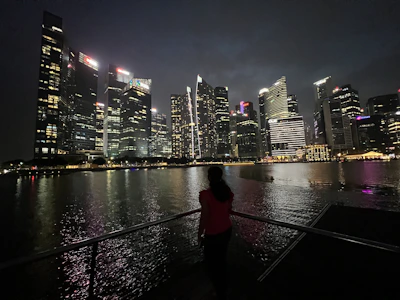 Evening city skyline with a model in Lumina apparel looking out over the view