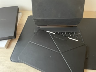 A stylish laptop open on a desk with accessories scattered around.