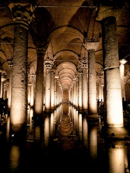 a very long hallway with columns and lights