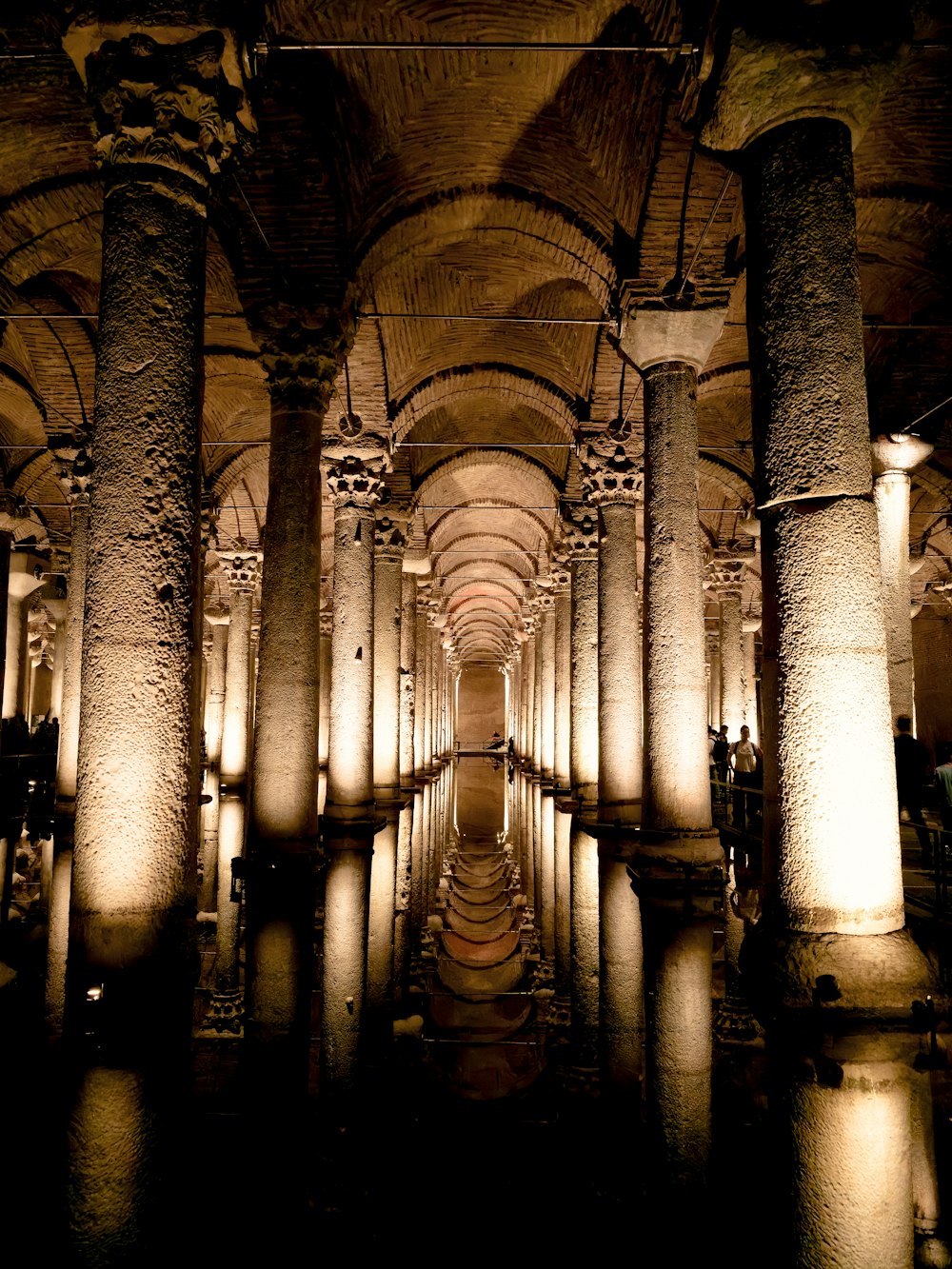 a very long hallway with columns and lights