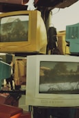 a pile of old televisions sitting on top of each other
