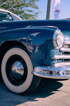 a classic car parked on the side of the road