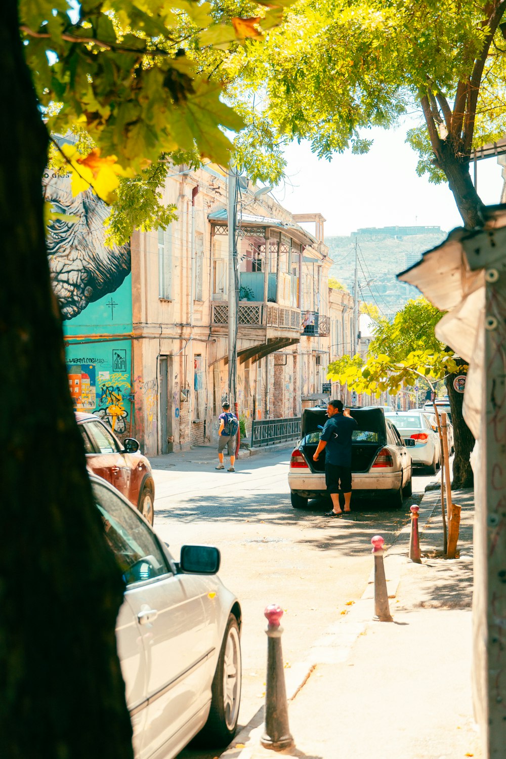 a couple of cars parked on the side of a road