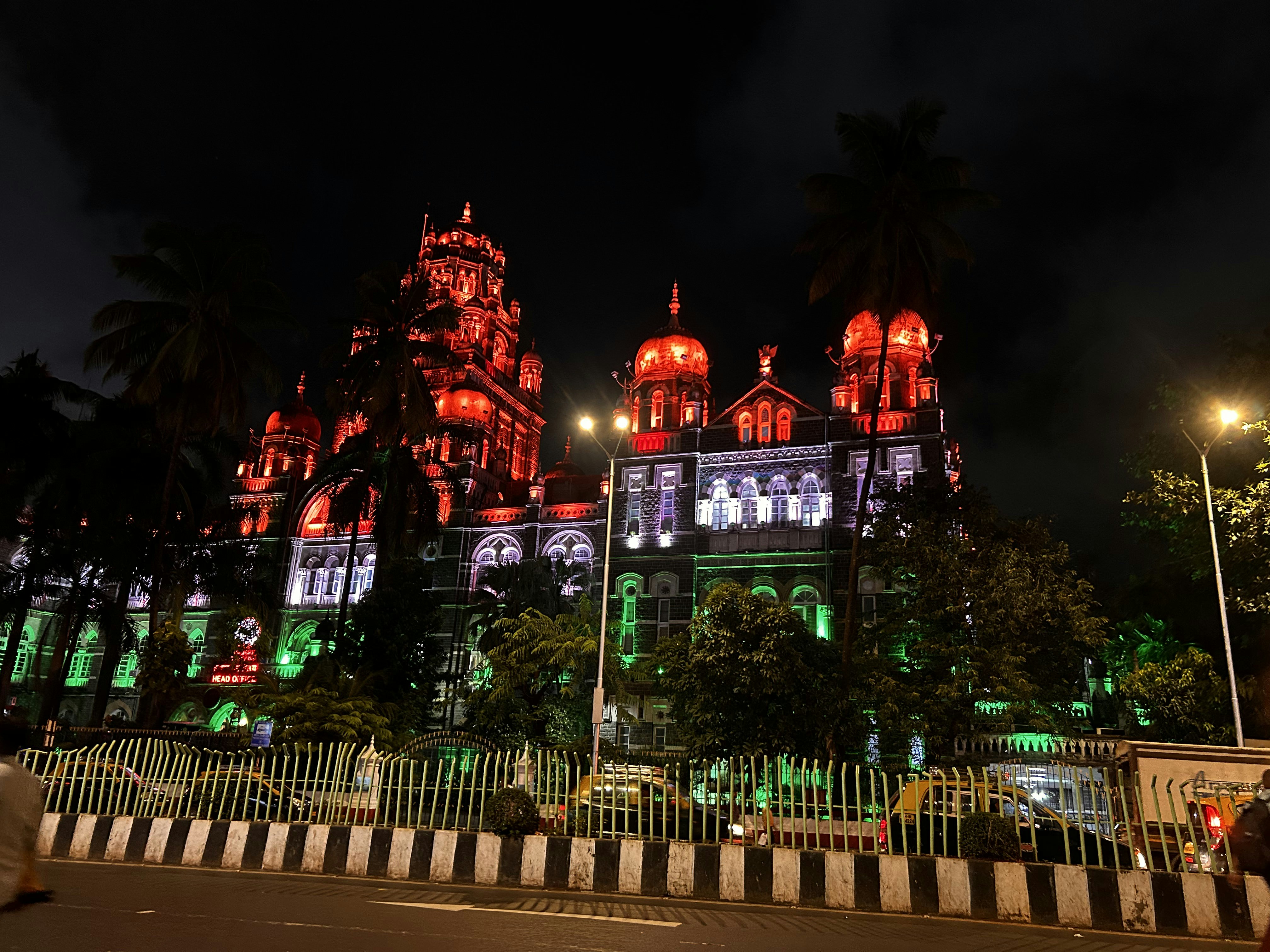 a large building lit up with red and green lights