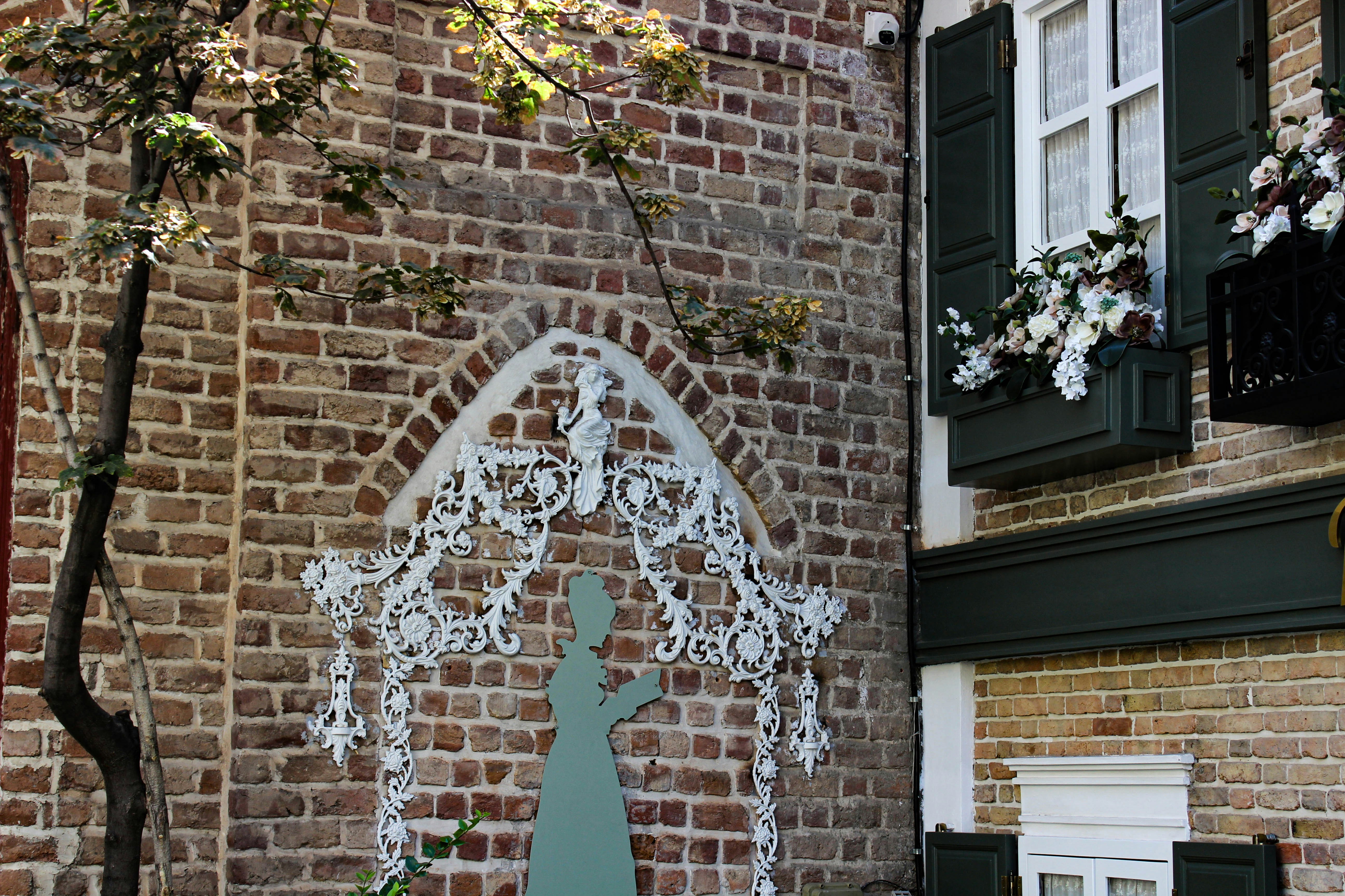 a clock on the side of a brick building