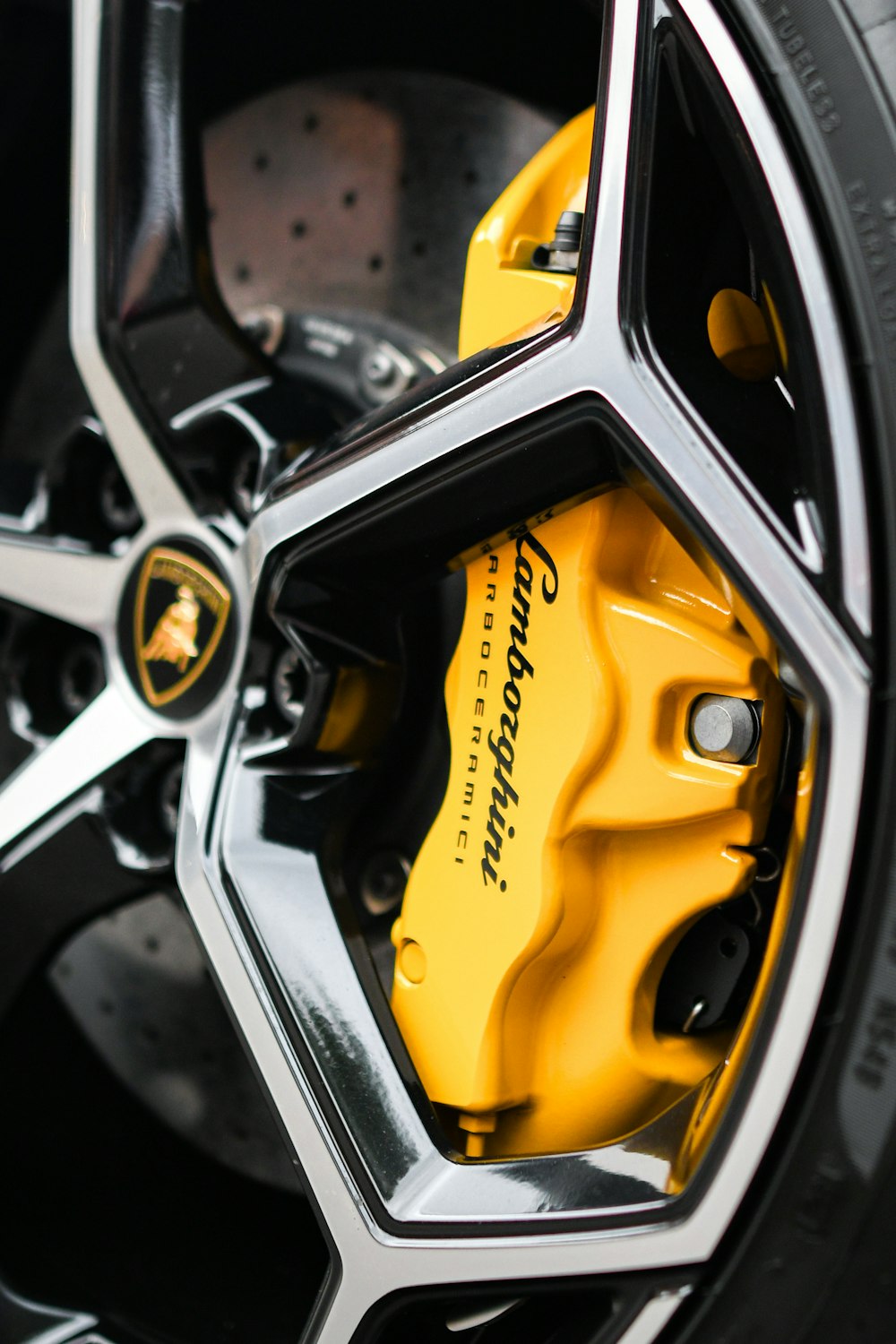 a close up of a yellow brake on a car