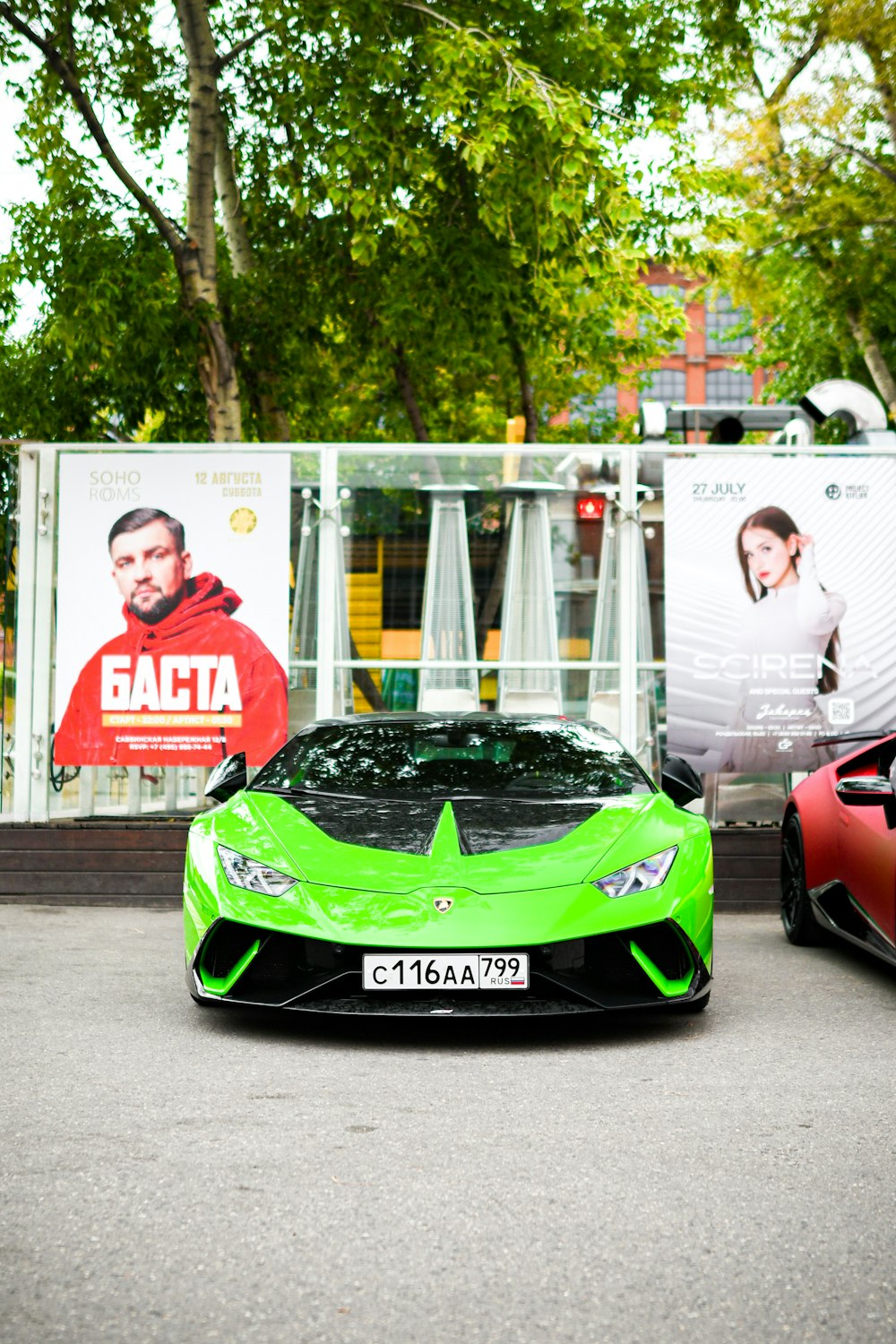 a green and red sports car parked next to each other