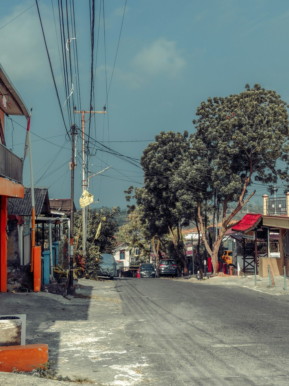 a street scene with a telephone pole in the middle of the street