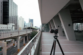 Dynamic urban travel scene featuring a male creator filming with a camera near an airport.