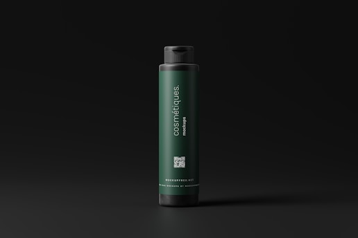 A dark green cylindrical bottle with a black cap stands against a dark background. The label on the bottle reads 'cosmétiques mockups' and includes a QR code as well as a website URL. The design is minimalistic and modern.