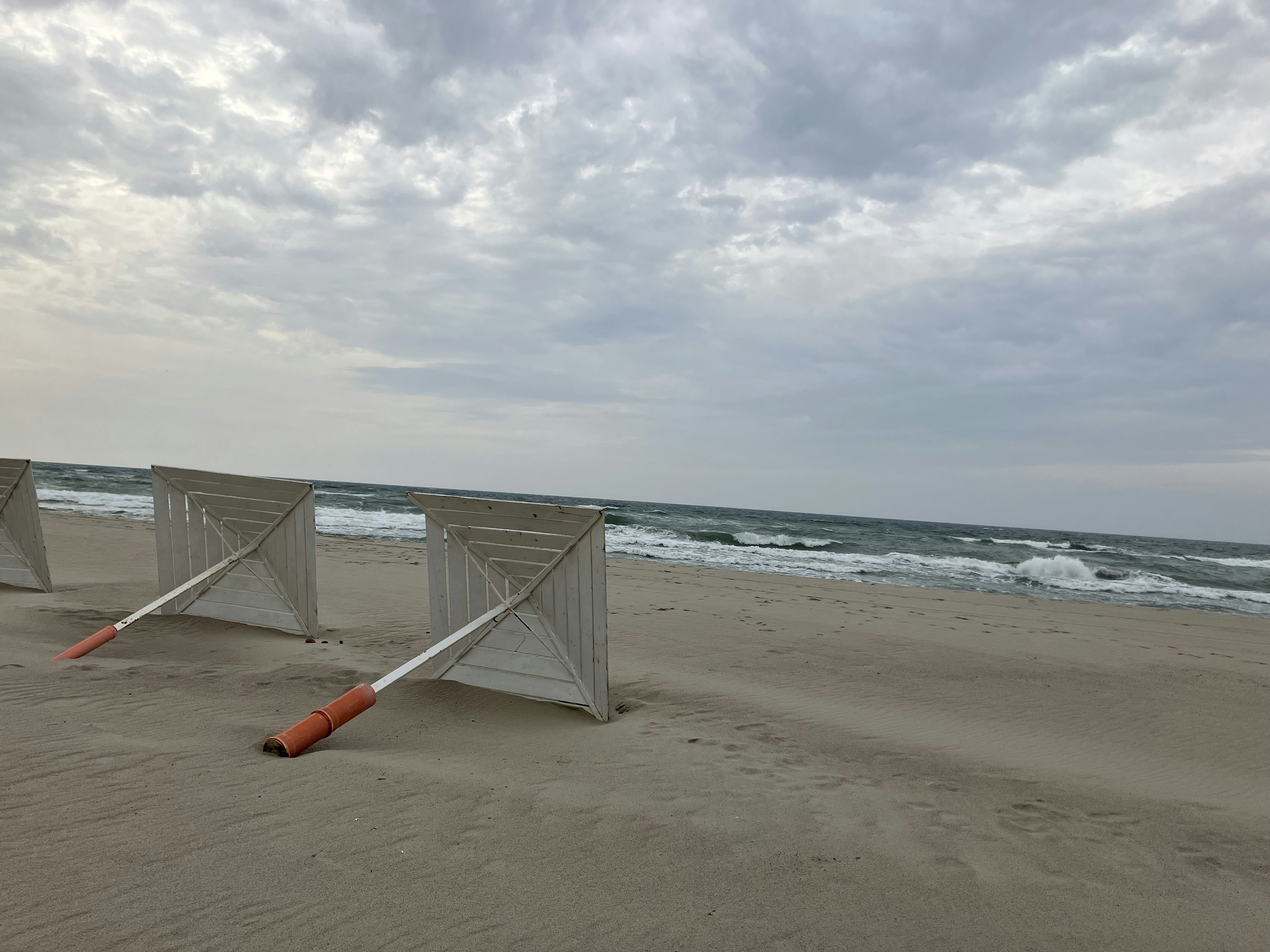 a couple of gates sitting on top of a sandy beach