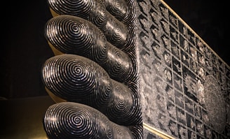 A close-up of intricate lippan art patterns on a textured surface.
