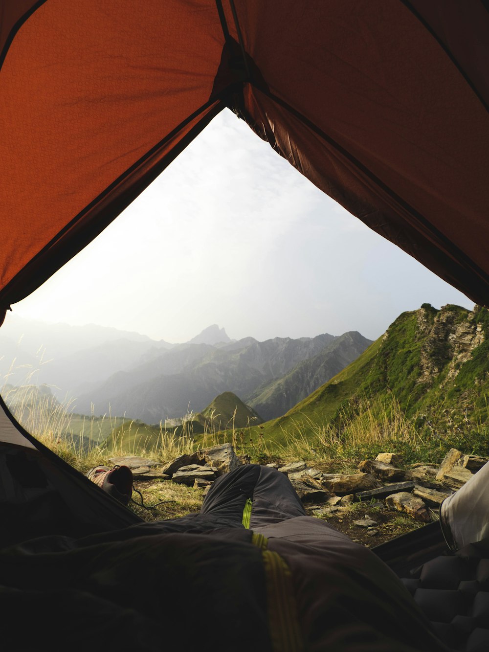 a view from inside a tent of a mountain range