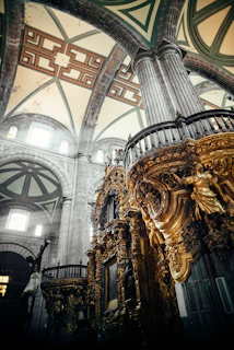 Interior of a restored Brazilian cathedral with ornate altars and historic frescoes illuminated by soft light.