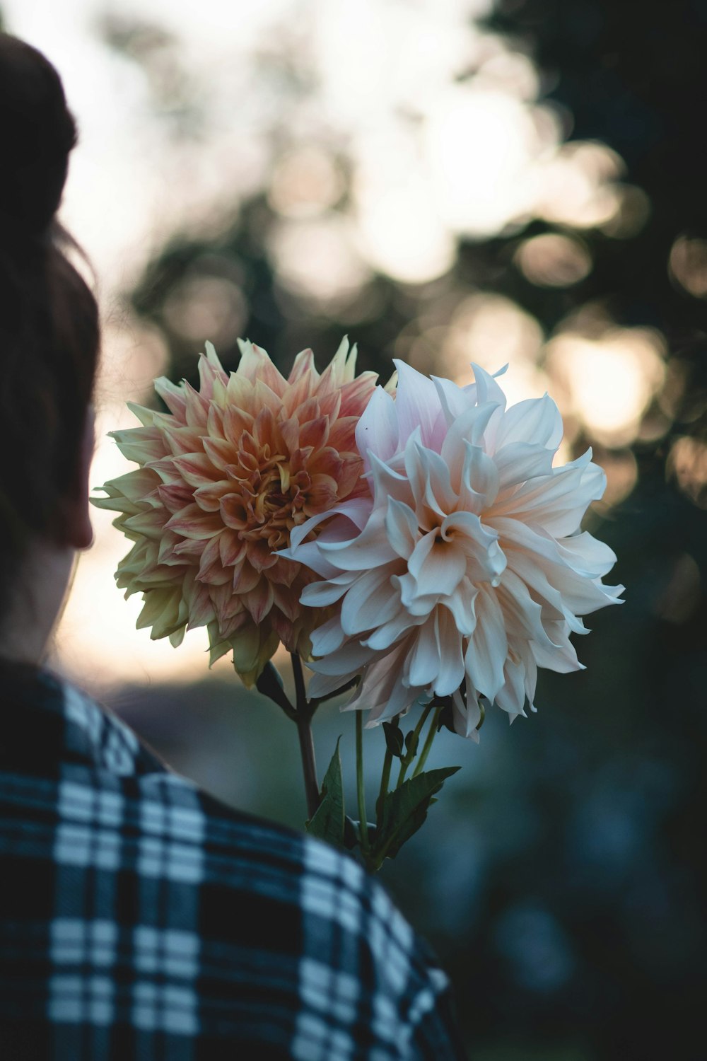 a close up of a person holding a flower