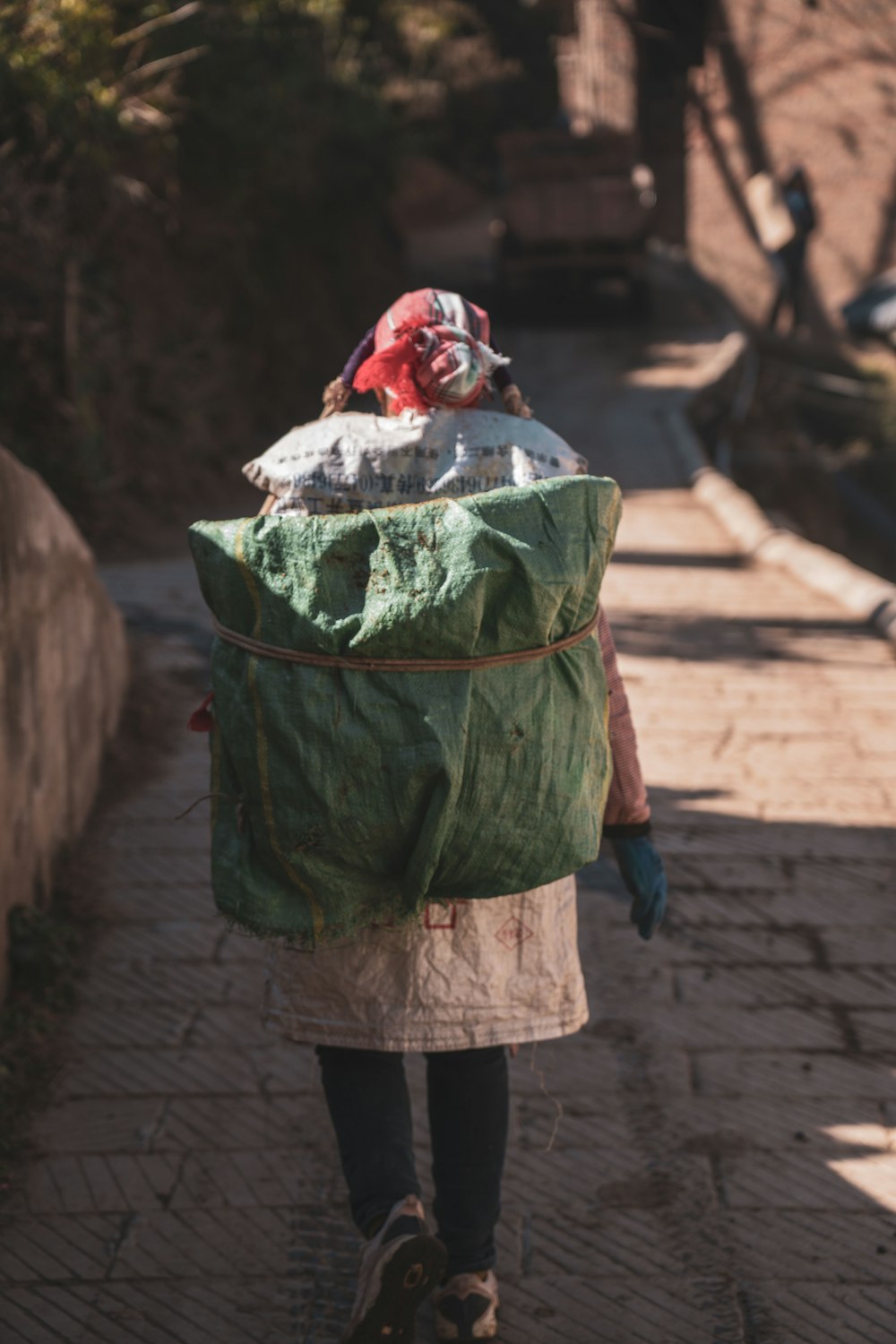 a person walking down a street with a bag on their back