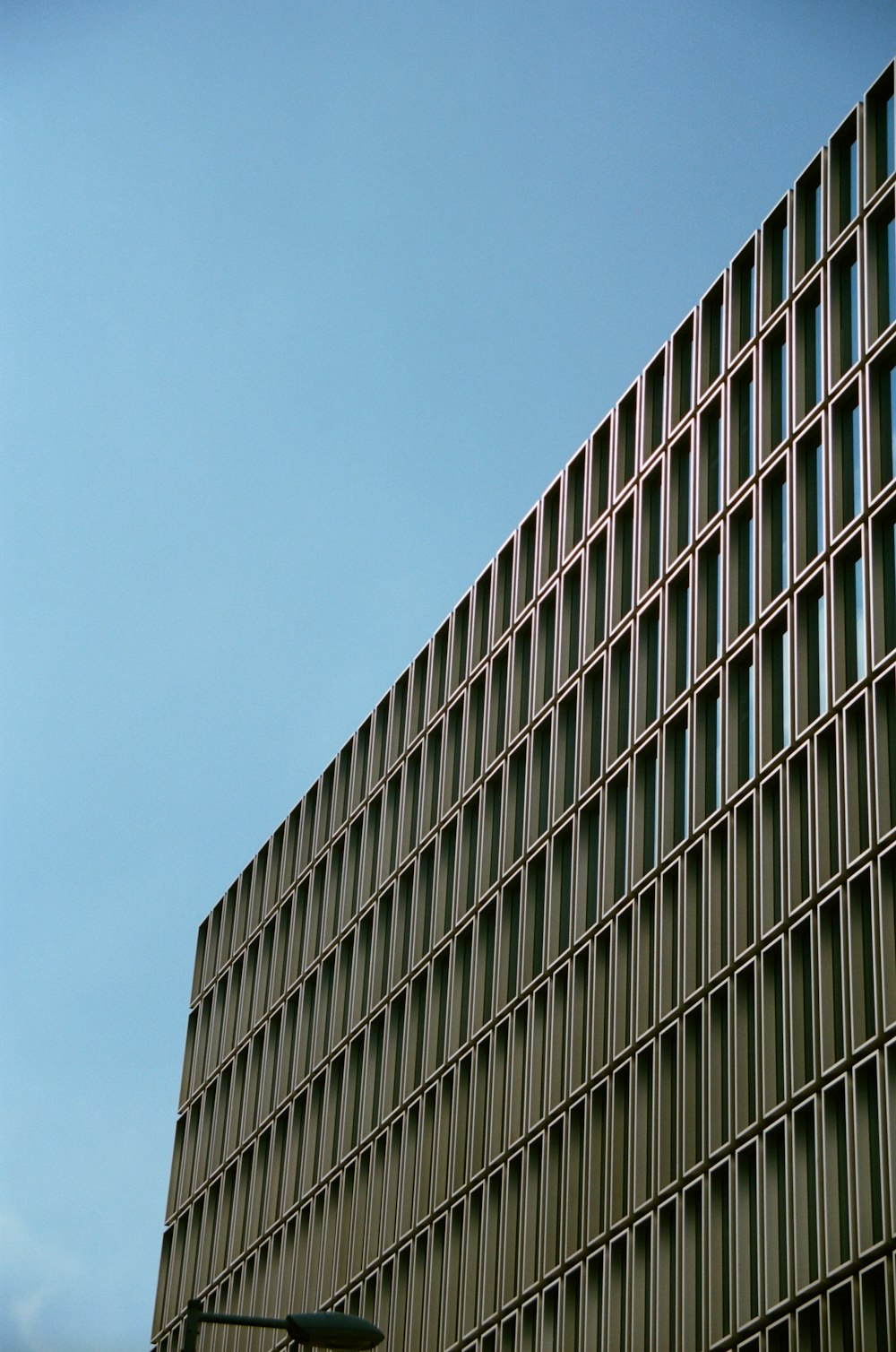 a tall building with lots of windows and a traffic light