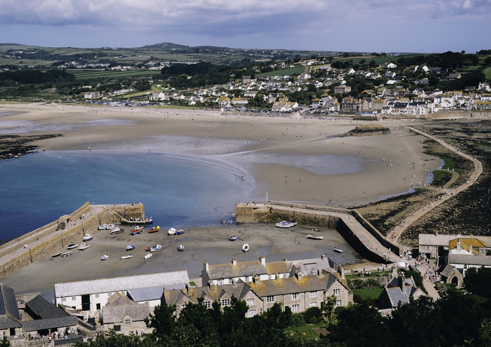 an aerial view of a beach with boats in the water