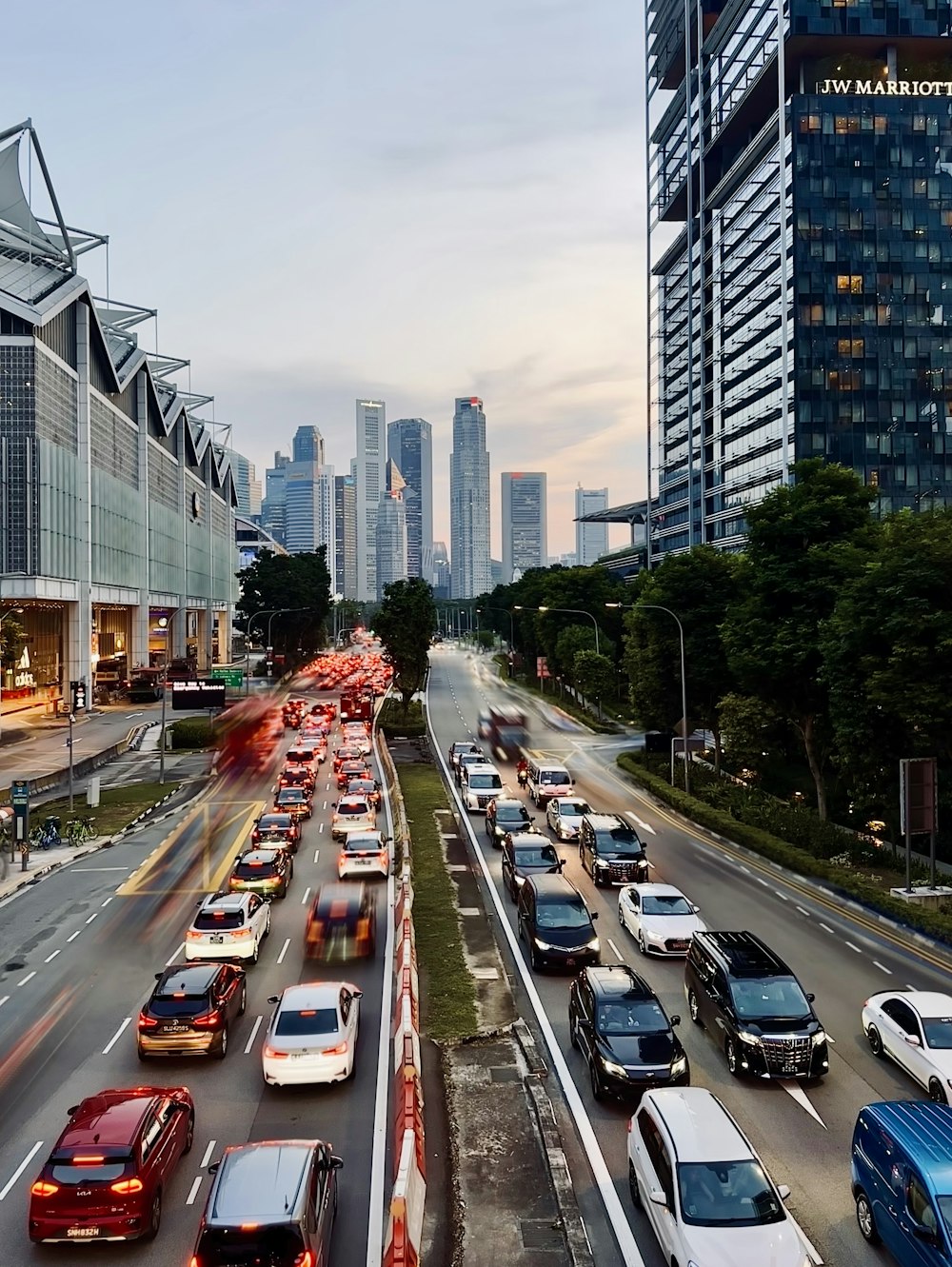 a highway filled with lots of traffic next to tall buildings