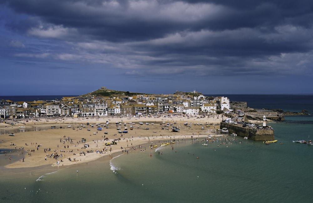 a group of people standing on top of a sandy beach