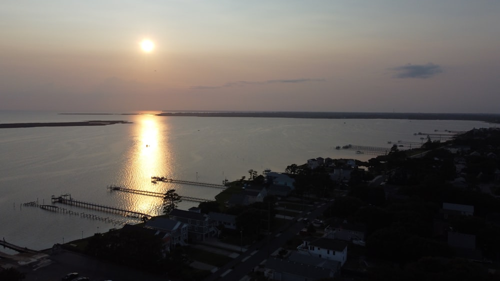 the sun is setting over a large body of water