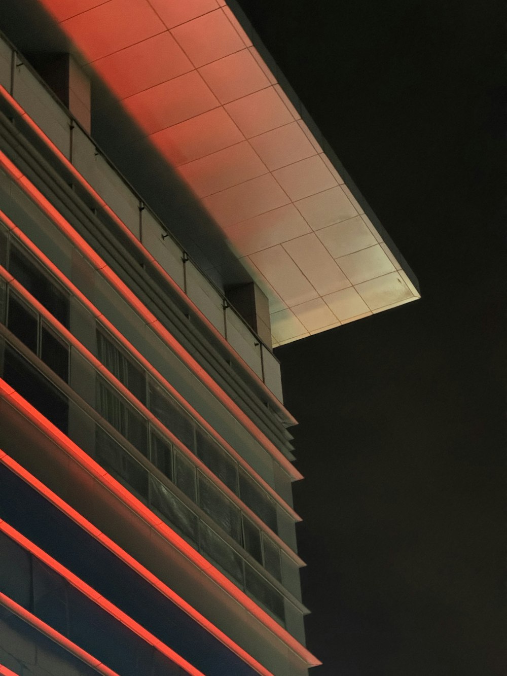 a tall building with a red light on it's side