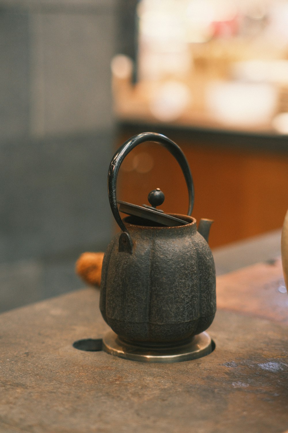 a black tea kettle sitting on top of a counter