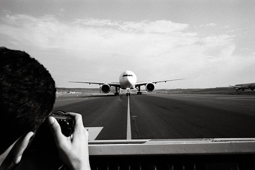 Photographer capturing a plane taking off from a scenic spot near Munich Airport.