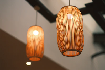 Modern pendant light with warm glow hanging over a kitchen island with natural wood accents.