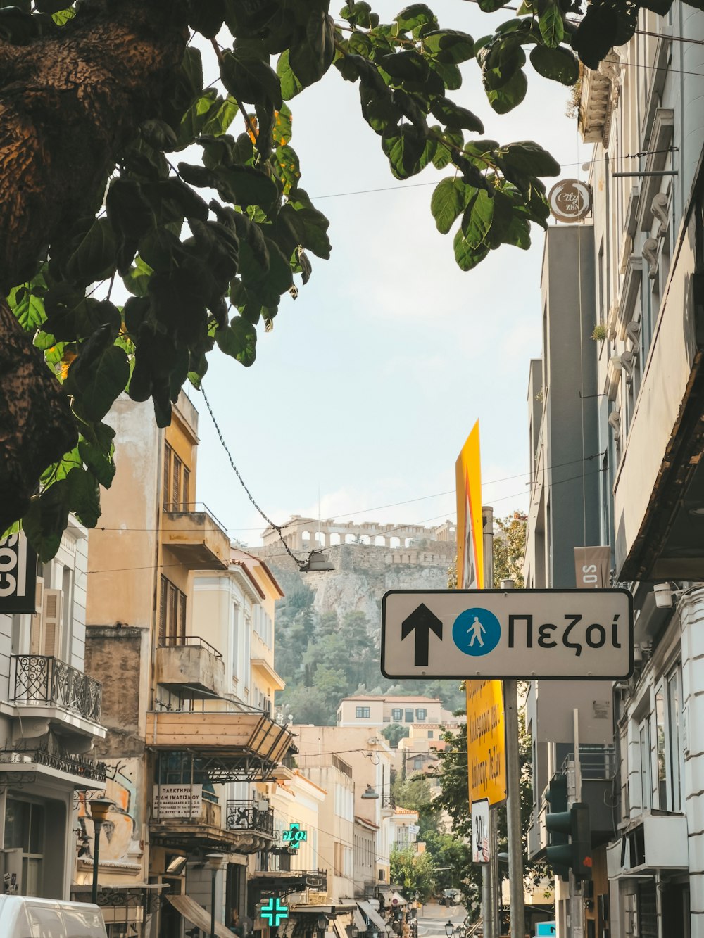 a street sign on a city street with buildings in the background