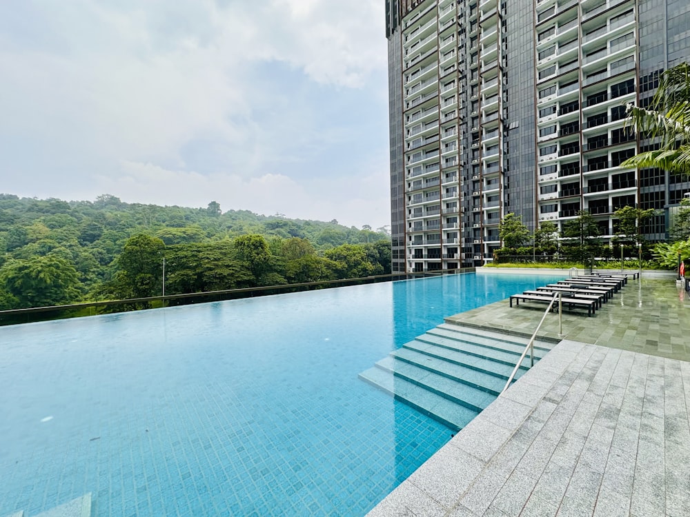 a large swimming pool next to a tall building