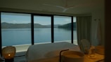 Modern bedroom featuring soft linens and tasteful decor overlooking the peaceful lake.