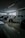Several cars are displayed inside a modern, well-lit showroom with a sleek and polished floor. Large windows provide natural light.