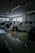 Several cars are displayed inside a modern, well-lit showroom with a sleek and polished floor. Large windows provide natural light.