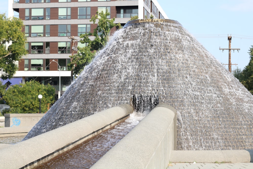 a water fountain with a large cone of water coming out of it