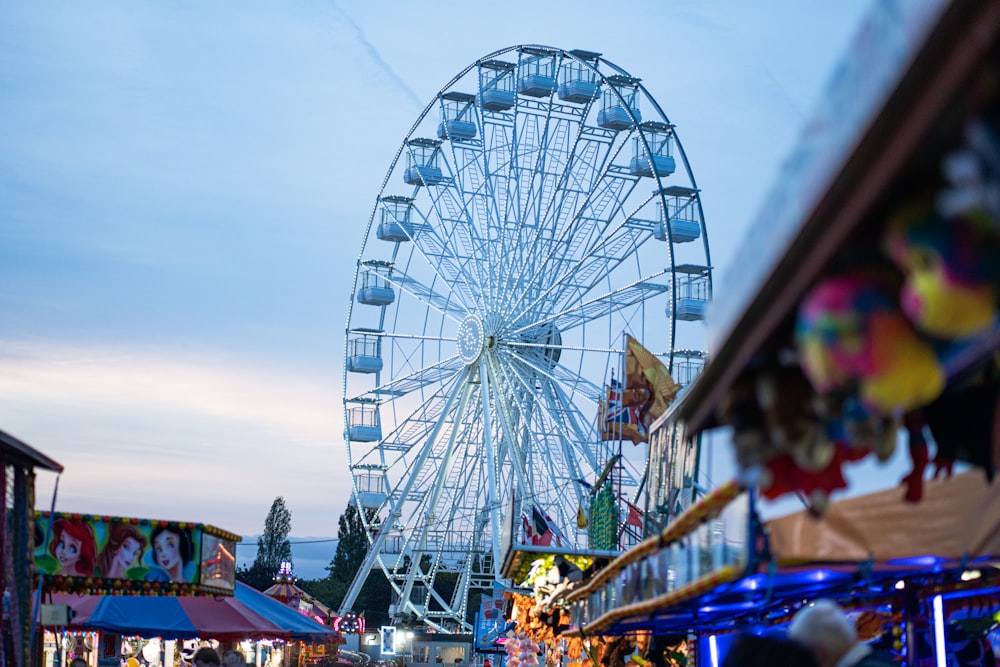 a carnival with a ferris wheel in the background