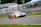 A dynamic shot of a race car speeding on a track with vibrant colors.