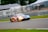 A dynamic shot of a race car speeding on a track with vibrant colors.