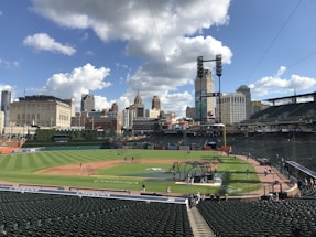 A friendly team member answering a phone call with a baseball field in the background.