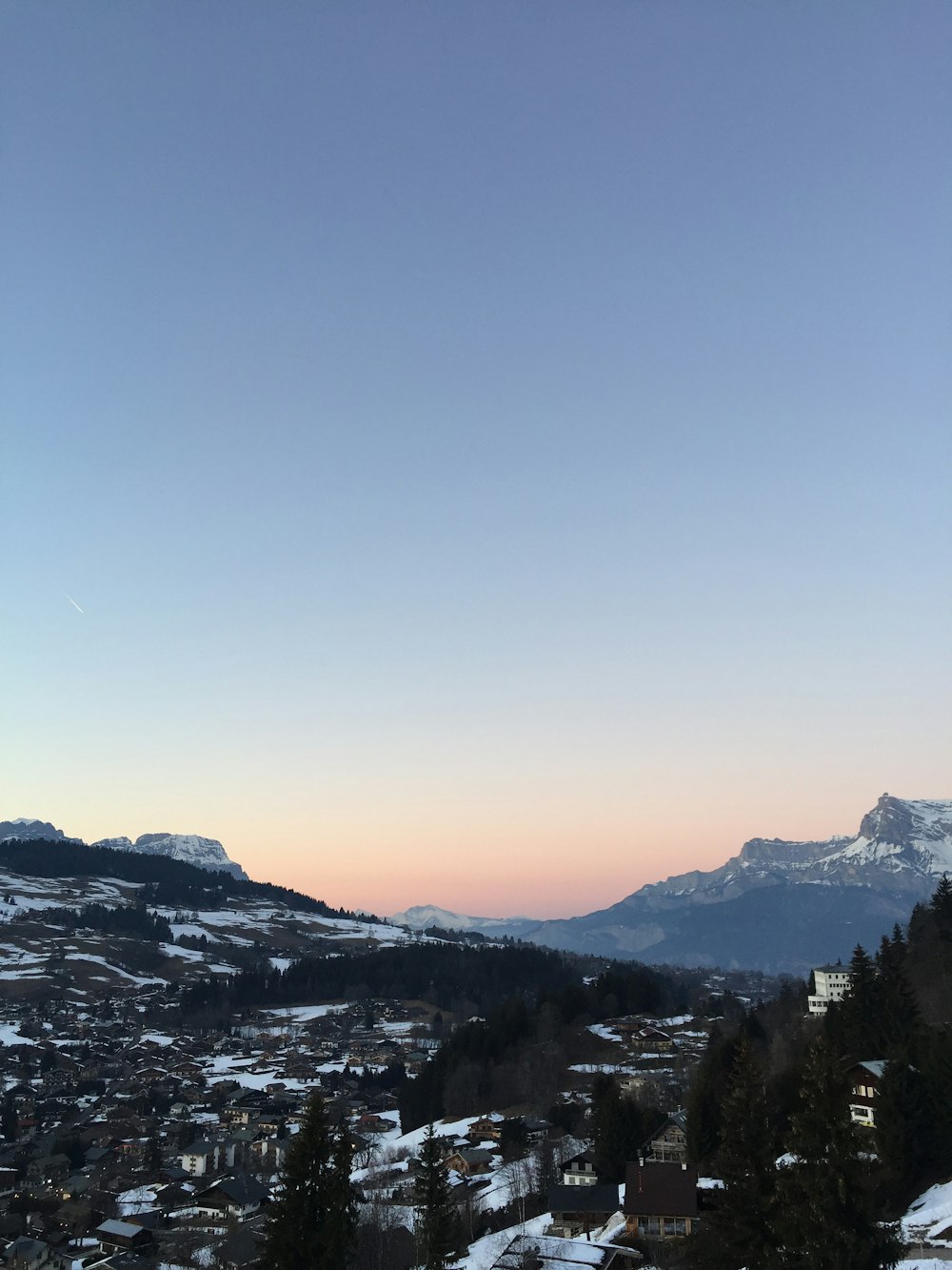 a view of a city with mountains in the background