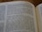 A close-up view of a page from an open book, specifically from the Old Testament, displaying text in paragraphs. The focus is on the words 'Israel’s restoration assured' and surrounding text, with some parts slightly blurred due to shallow depth of field.