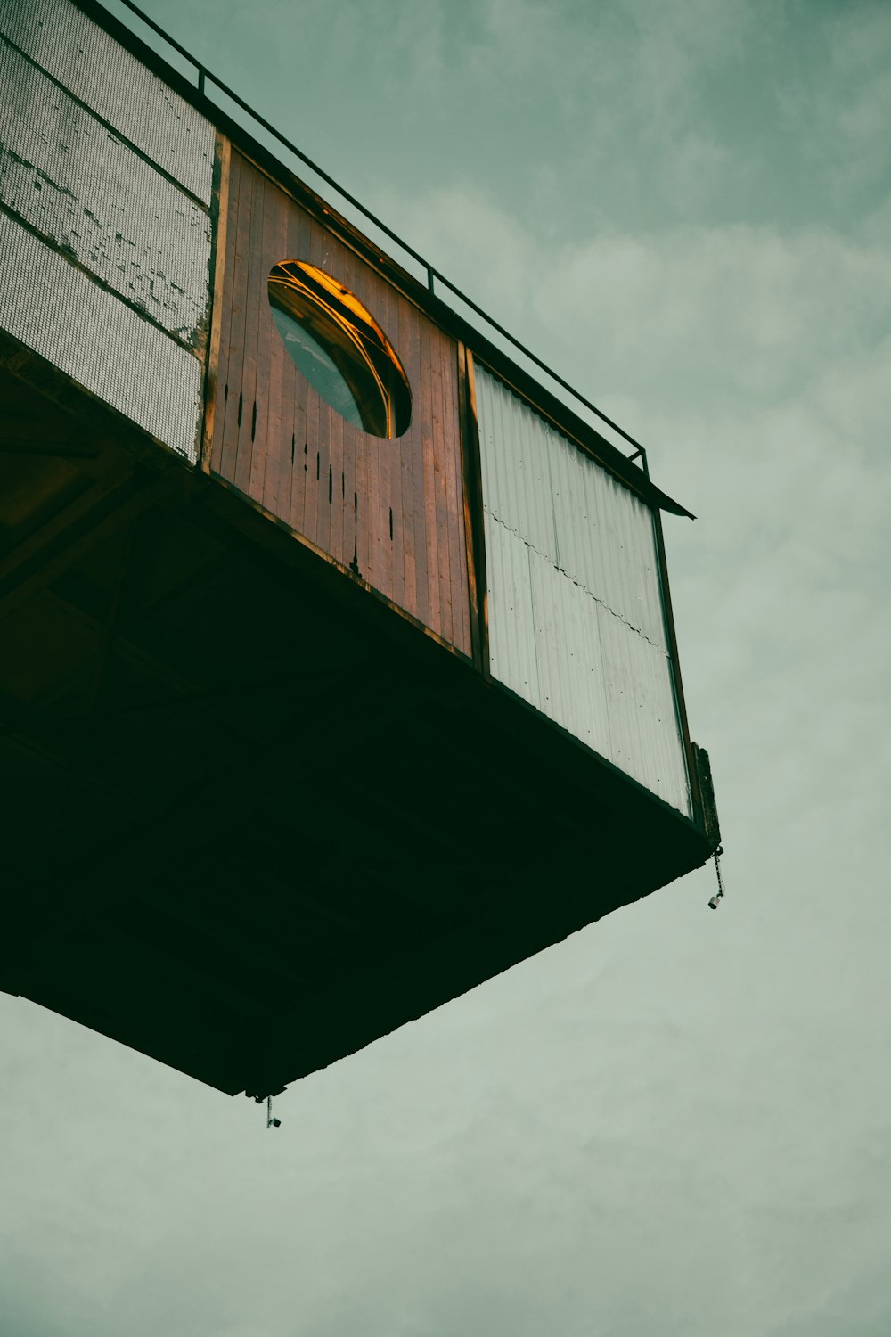 a tall wooden structure with a window on top of it