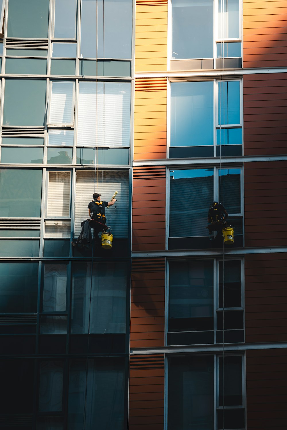 a man on a window washer washing windows