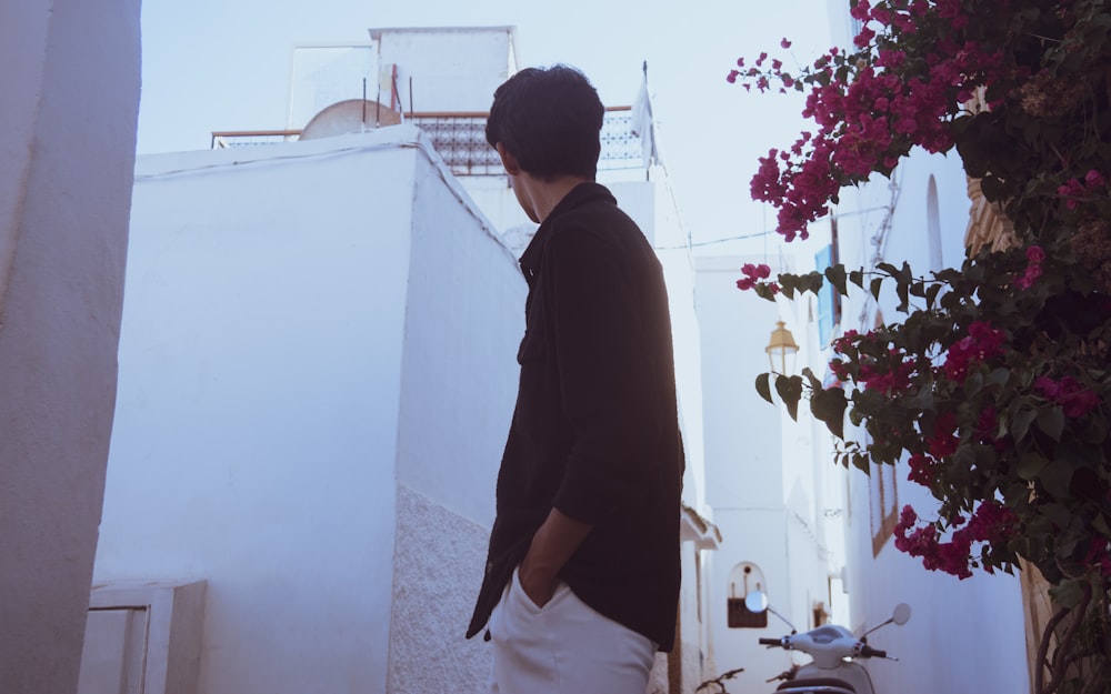 a man standing in front of a white building