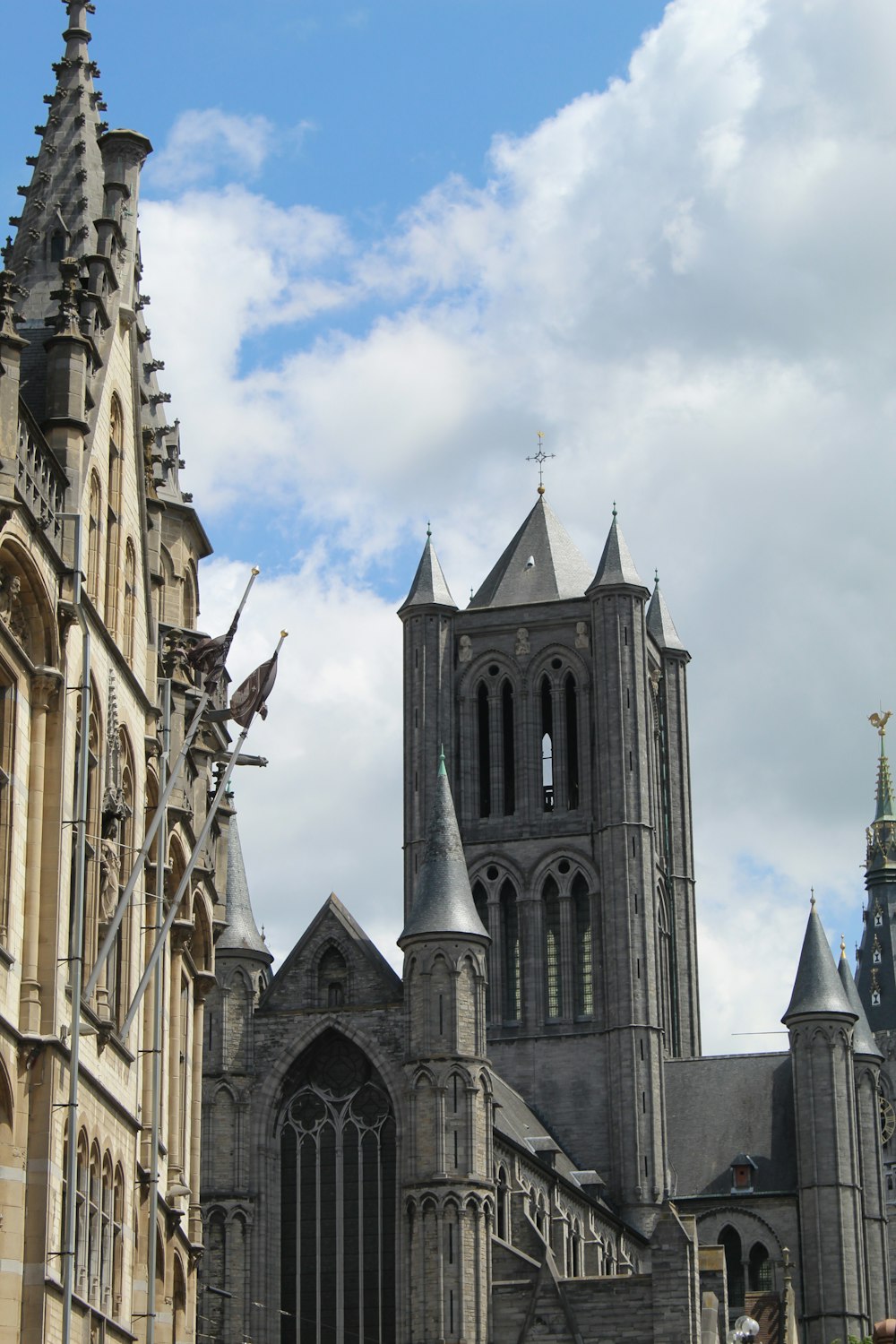 a large cathedral with a clock tower on a cloudy day