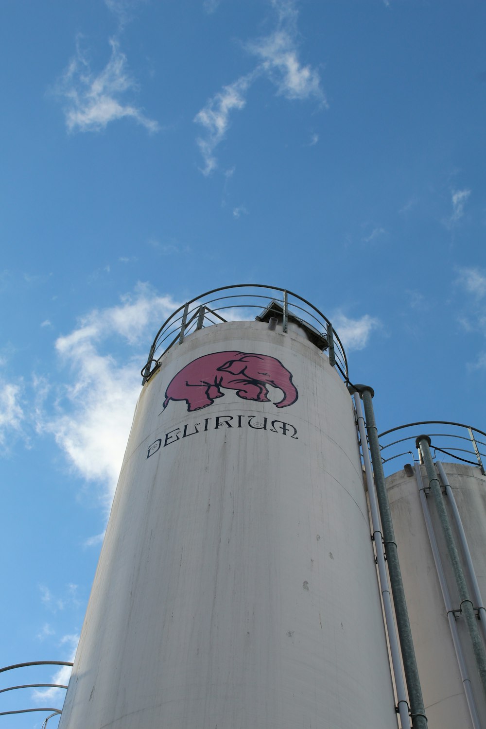 a large white silo with a pig on it's side