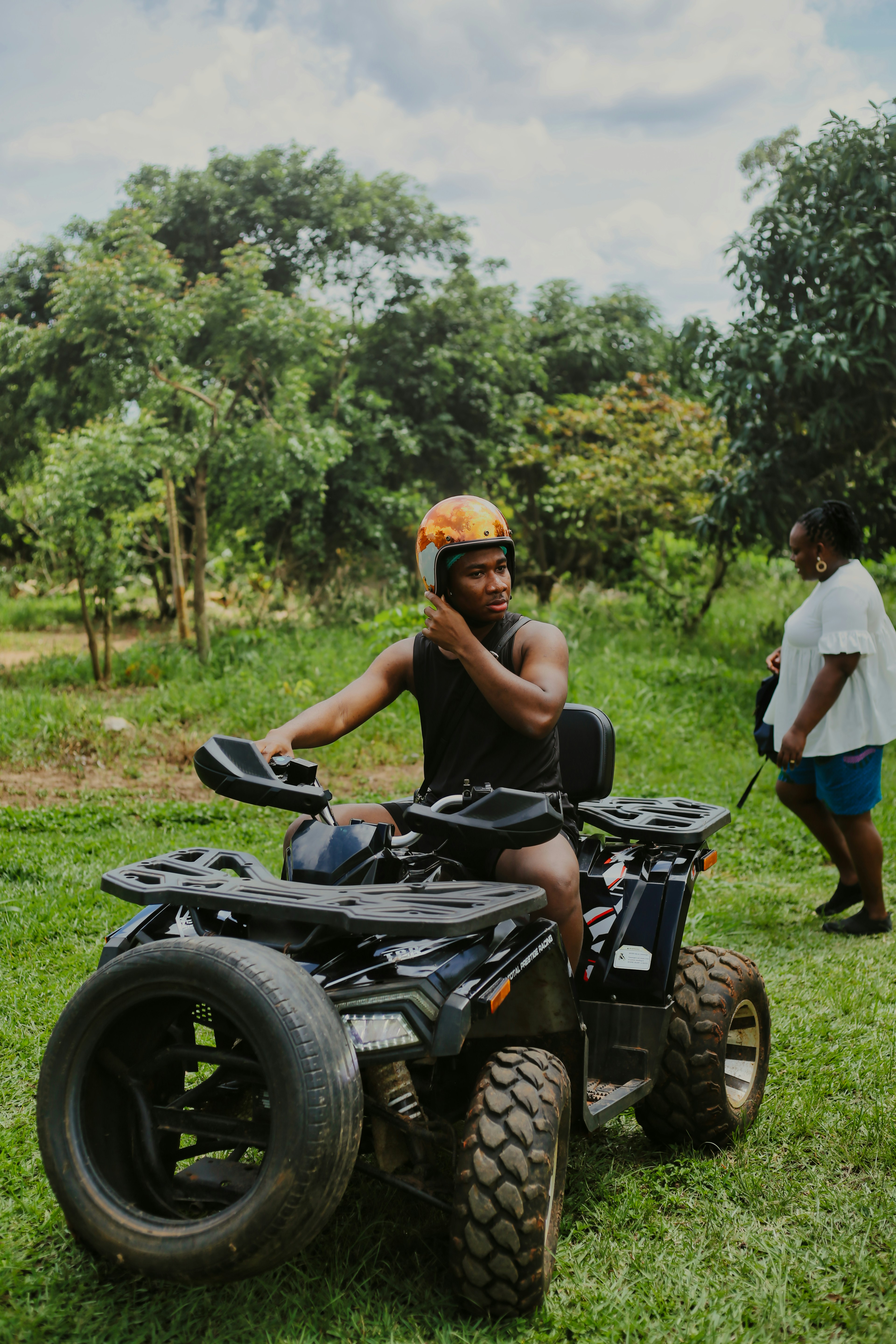 A man riding an atv on a lush green field photo – Free Ghana Image on ...