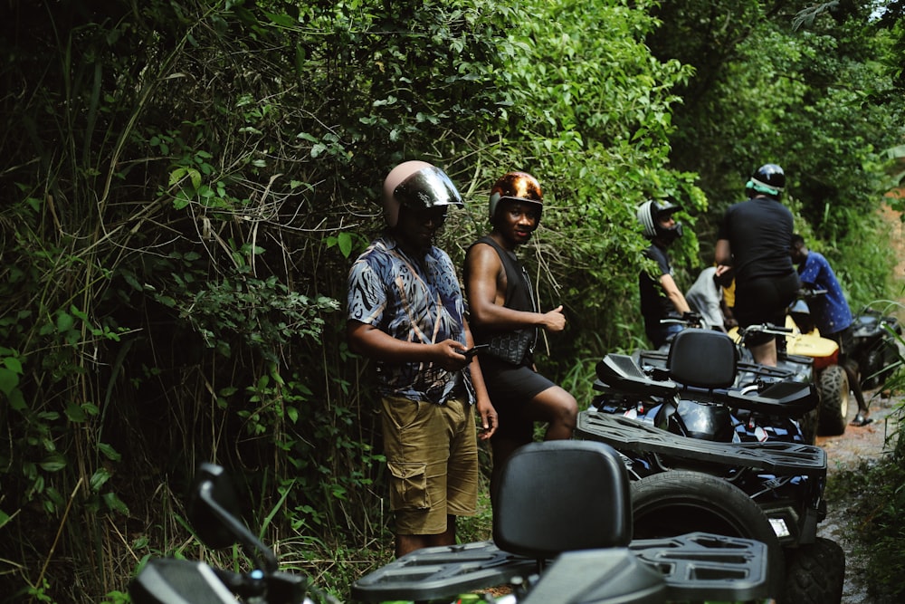 a group of people standing next to motorcycles